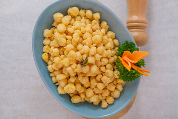 Crispy Salted Egg Corn Served On Plate With Parsley And Carrot Garnish, Perfectly Presented On Background Surface.
