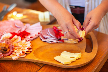 Obraz premium Preparing Cheese for Serving Platter