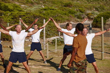 Men, fitness or training with army for military bootcamp or physical activity on grass field. Male people, trainer or superior officer with team or soldiers in drill or star jumps for endurance test