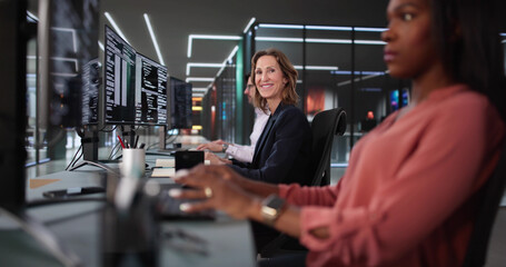 African American coder happily coding on desktop