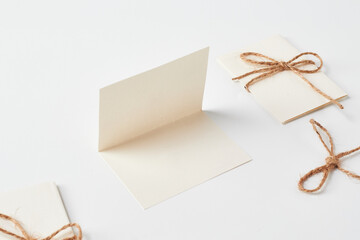 Blank Greeting Cards With Twine Accents Arranged on a White Background for Creative Endeavors