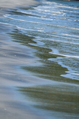 The sea water on the beach is a wave of various forms for background.