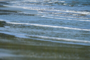The sea water on the beach is a wave of various forms for background.