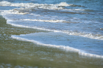 The sea water on the beach is a wave of various forms for background.