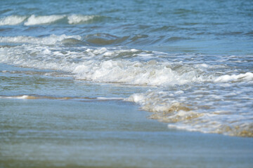 The sea water on the beach is a wave of various forms for background.
