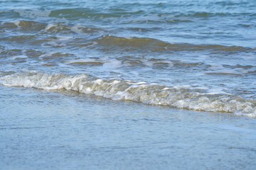 The sea water on the beach is a wave of various forms for background.