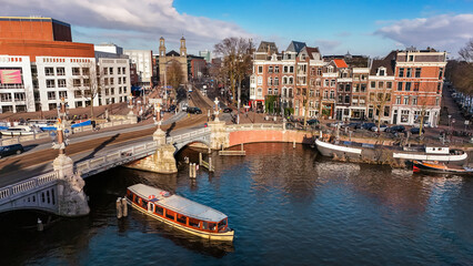 Amsterdam city center aerial view from above, historic buildings, dutch architecture and canal with boats and bridge, Amsterdam drone cityscape, the Netherlands