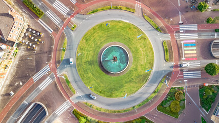 Road ring junction with bike paths and pedestrian crossings aerial drone view from above, urban transportation, Venlo, the Netherlands
