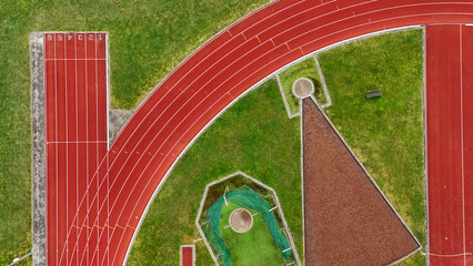 Running track aerial drone view from above, athletic stadium with track lines bird’s view, sport...