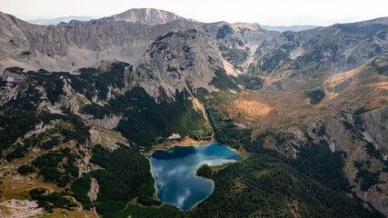Fototapeta premium Aerial view of mountain lake and peaks