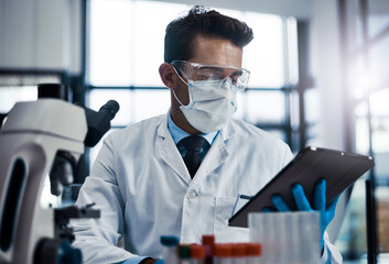 Scientist, research and man in lab, tablet and equipment with breakthrough, app and internet. Person, researcher or employee with tech, microbiology or cure development with face mask or clinic trial