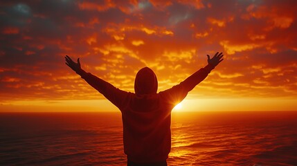 Fototapeta premium A person standing with their back arms raised in a victorious pose