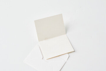 Blank White Greeting Card Placed Next to an Empty Envelope on a Clean Surface