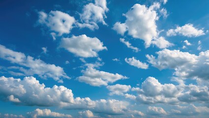 Fototapeta premium Blue sky with scattered fluffy clouds during daytime minimalistic landscape background