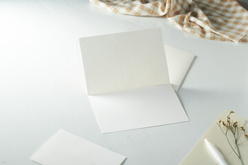 Blank Greeting Card on a Clean Table With Natural Light and a Checkered Cloth in the Background