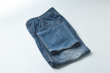 Folded Blue Denim Jeans on a White Background Ready for Storage or Sale