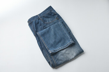 Folded Blue Jeans Displayed on a Flat Surface With a Minimalist Background