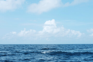 landscape of horizontal calm blue sea with wave and cloud and blue sky in bright day. Travel destination summer of ocean in Bali, Indonesia