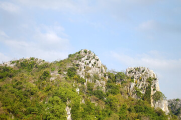 landscape rocky mountain and forest on hill with cloud and blue sky in Thailand. Copy space

