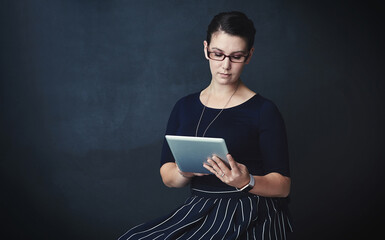 Woman, web designer or studio with tablet for online or digital marketing on a dark background....