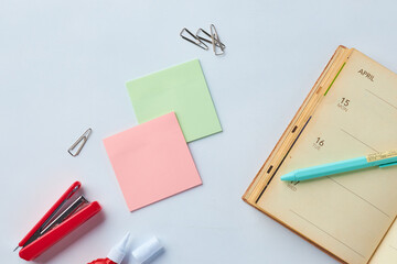 Stationery Arrangement With Sticky Notes, a Planner, and Office Supplies on a Clean Workspace