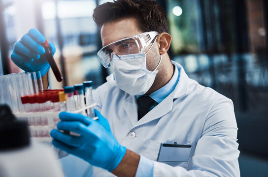 Man, scientist and vial with blood sample at lab of medical virus, study dna and drug development. Male person, face mask and container for genes engineering, clinical research and healthcare vaccine - Powered by Adobe