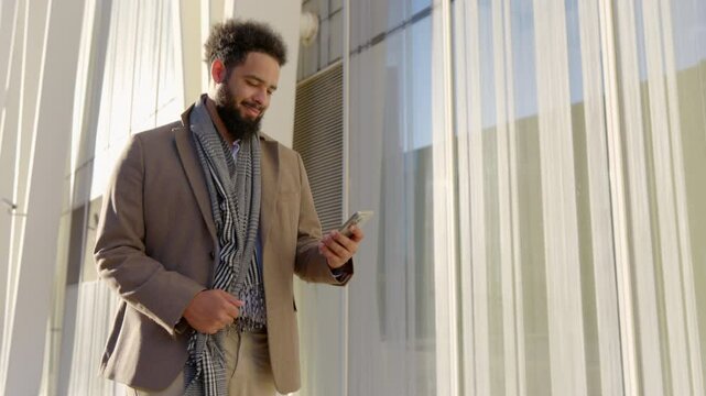 Confident businessman outside is focused on his phone, representing modern professionalism, leadership, and innovative strategies, showcasing adaptability and success in todays business world
