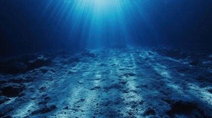 Naklejka premium Dramatic Underwater Scene Sunbeams Illuminate Ocean Floor Rocky Seabed Texture