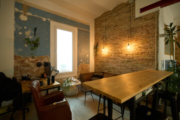 Modern coworking space with exposed brick wall and warm lighting