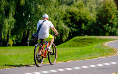 Cyclist ride on the bike path in the city Park

