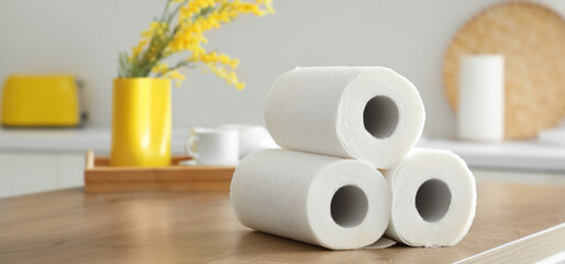 Rolls of paper towels on table in kitchen, closeup