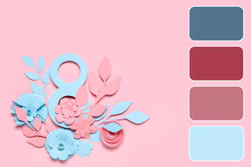 Paper flowers and figure 8 on pink background. Different color patterns for International Women's Day