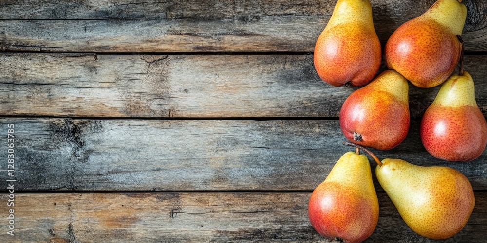 Poster Ripe yellow and red pears clustered on a rustic wooden table with ample negative space on the left for text overlay in a top view composition