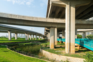 Concrete structure and asphalt road space under the overpass in the city