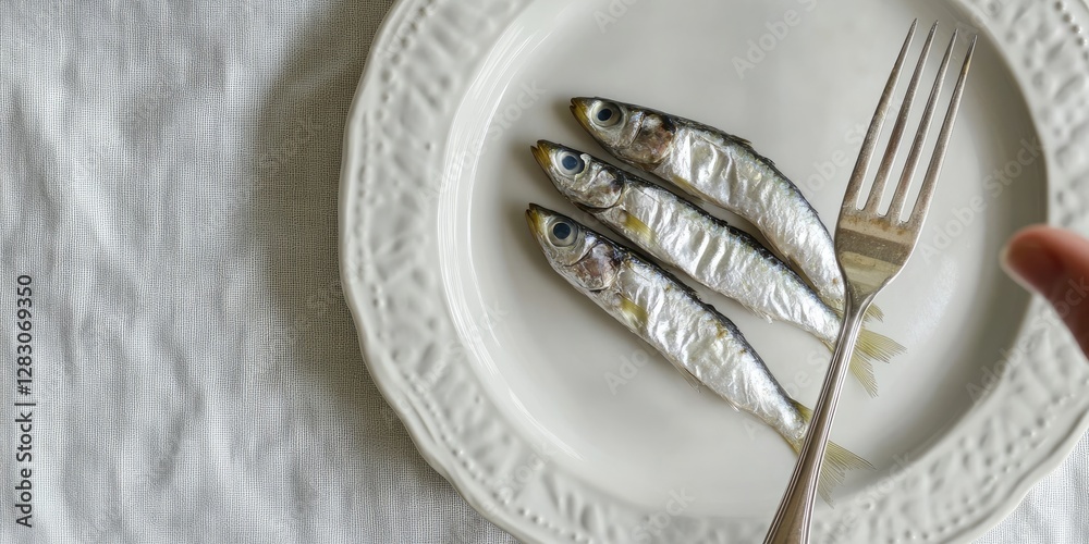 Poster three silver fish neatly arranged on a white plate with a decorative rim positioned at the center, a