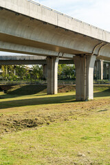 Concrete structure and asphalt road space under the overpass in the city