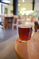 Warm tea resting on a wooden table in a cozy cafe setting