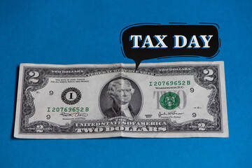 Tax day corresponding to April 15, 2025, deadline for filing national taxes. 2 dollar bill, tax...
