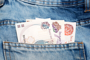 Manx pound  in the pocket of blue jeans