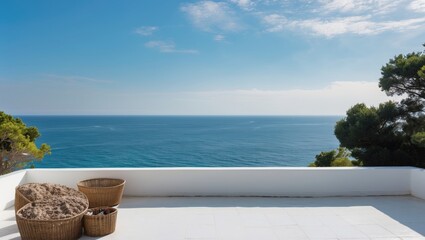 Obraz premium Cozy terrace with beach chairs and baskets overlooking tranquil ocean view with clear blue sky and greenery in the foreground Copy Space
