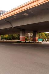 Concrete structure and asphalt road space under the overpass in the city