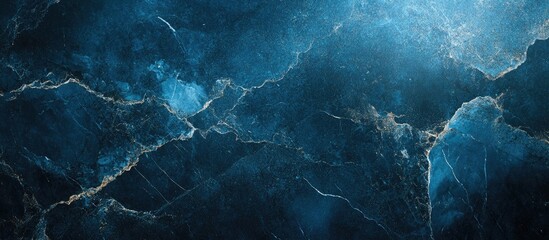 Naklejka premium Dark blue abstract marble texture with white crack lines, soft lighting from the top left, creating a moody and elegant background composition.
