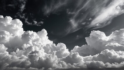Monochrome sky with dramatic clouds and wispy formations against a dark background displaying texture and depth in black and white