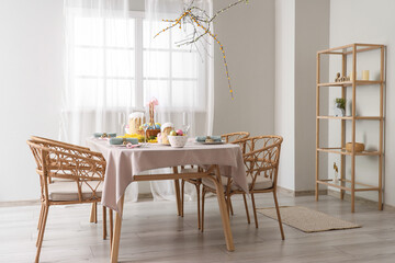 Beautiful table setting for Easter cakes and eggs in dining room