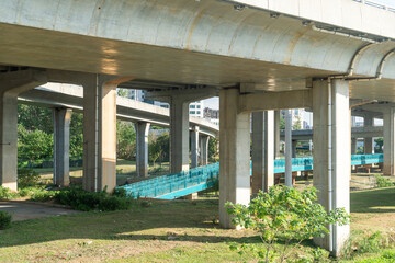 Concrete structure and asphalt road space under the overpass in the city