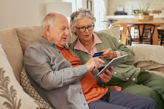 Senior couple paying online with credit card