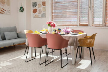 Interior of stylish dining room with Easter table setting