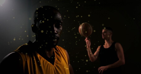 Image of moving spots over diverse male basketball players playing with basketball