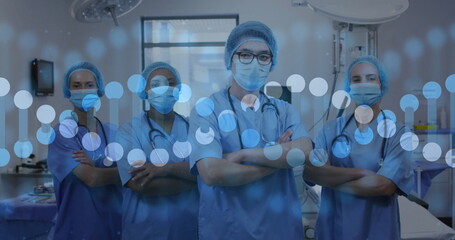 Image of dna strand over diverse doctors with face masks