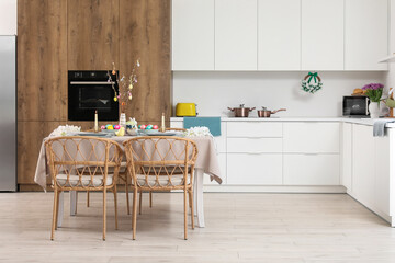 Interior of modern kitchen with festive table serving for Easter celebration